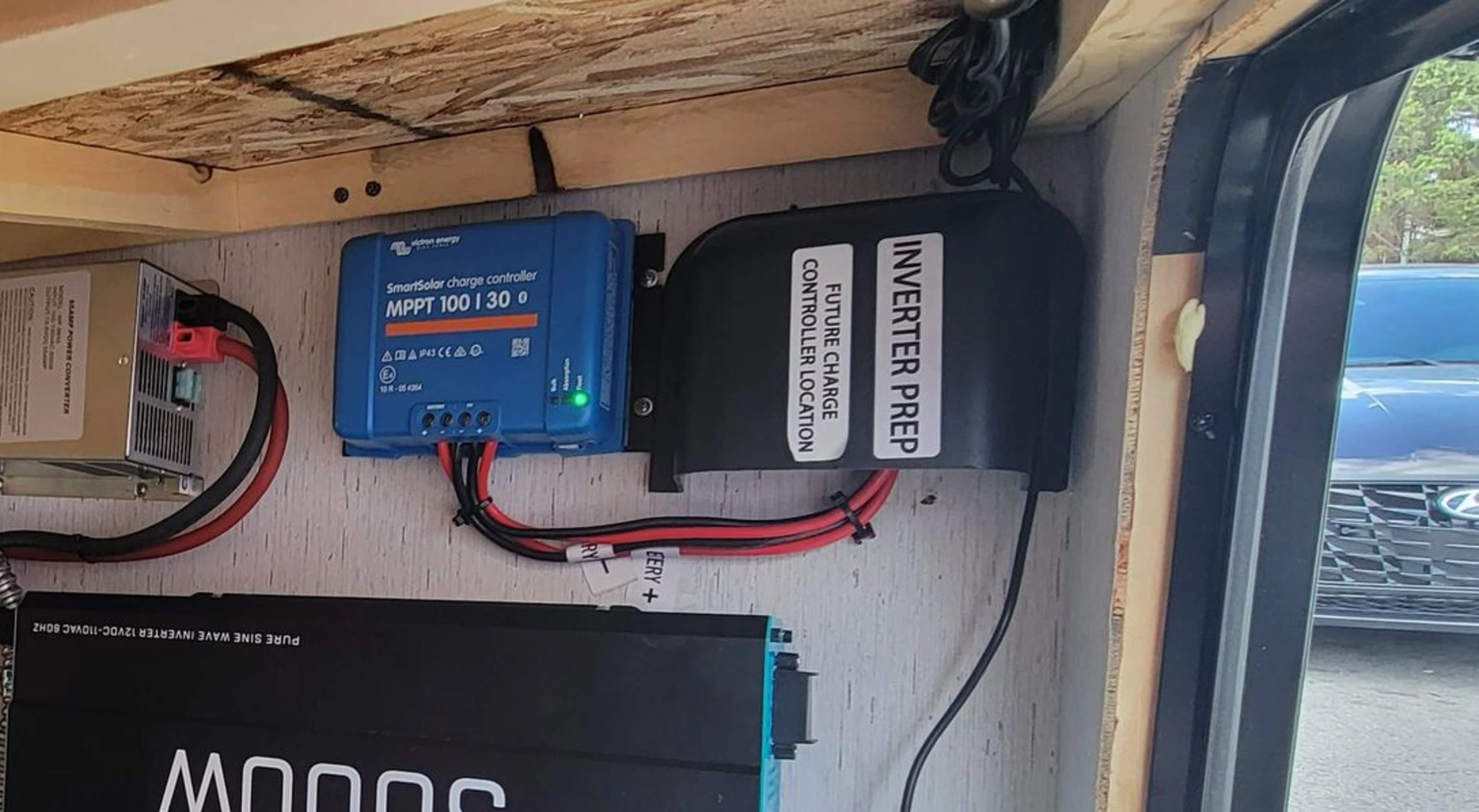 The Inverter prep cover inside of the pass-through compartment of an inverter-prepped bumper-pull travel trailer.